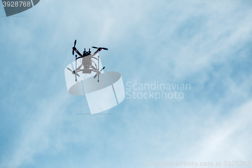 Image of flying drone with camera on the sky