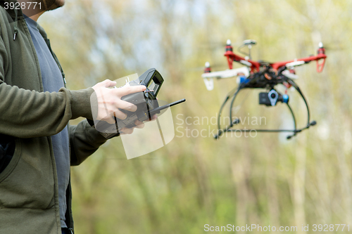 Image of Man controling a drone.