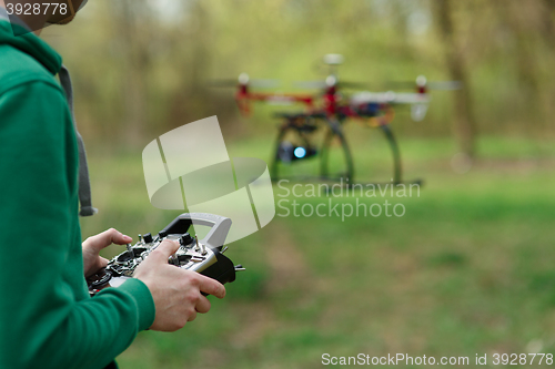 Image of Man controling a drone.