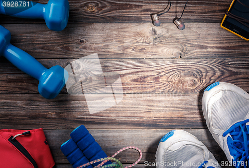 Image of Sport stuff on wooden table, top view