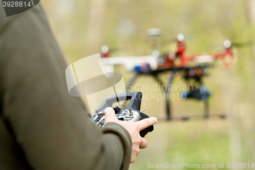 Image of Man controling a drone.