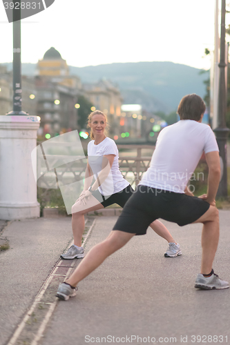 Image of couple warming up before jogging