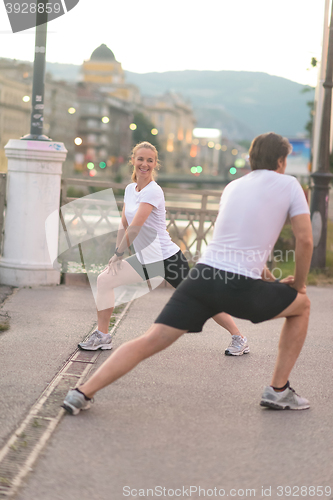 Image of couple warming up before jogging