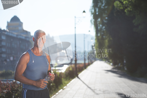 Image of portrait of handsome senior jogging man