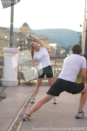 Image of couple warming up before jogging