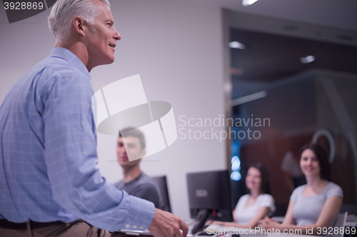 Image of teacher and students in computer lab classroom