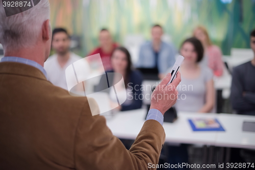 Image of teacher with a group of students in classroom