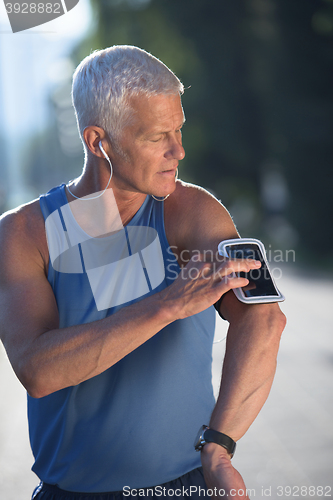 Image of portrait of handsome senior jogging man