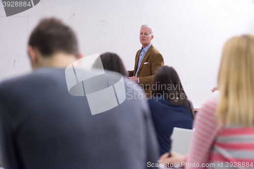Image of teacher with a group of students in classroom