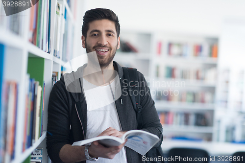 Image of portrait of student while reading book  in school library