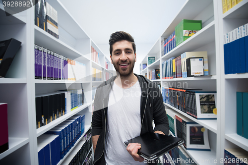 Image of student with tablet in library