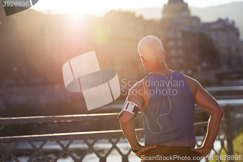 Image of portrait of handsome senior jogging man