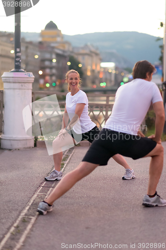 Image of couple warming up before jogging