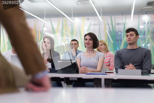 Image of teacher with a group of students in classroom