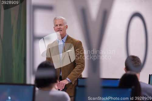 Image of teacher and students in computer lab classroom