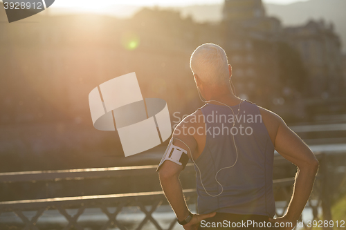 Image of portrait of handsome senior jogging man