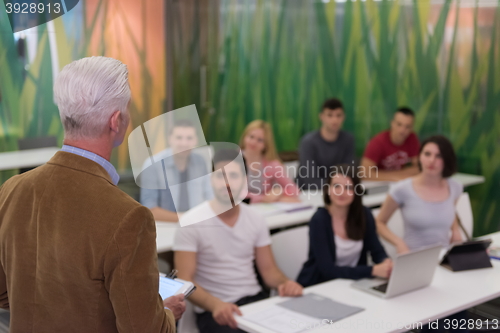 Image of teacher with a group of students in classroom