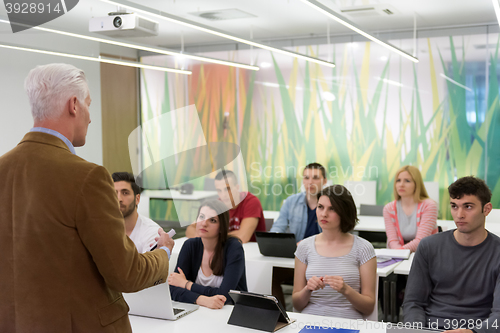 Image of teacher with a group of students in classroom