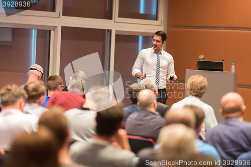 Image of Business speaker giving a talk in conference hall.