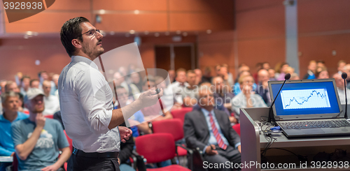 Image of Public speaker giving talk at Business Event.