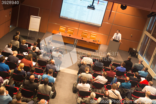 Image of Business speaker giving a talk in conference hall.