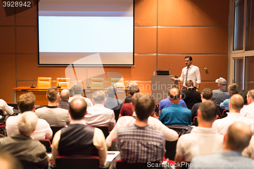 Image of Business speaker giving a talk in conference hall.