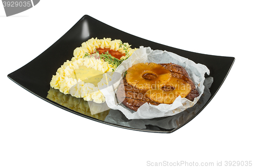 Image of Pork tenderloin with grilled pineapple. Macro. Isolated white background