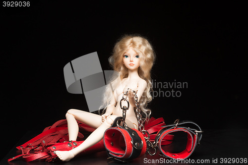 Image of concept. Doll with different sex toys.