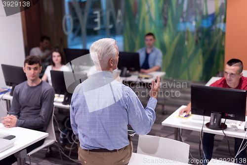 Image of teacher and students in computer lab classroom