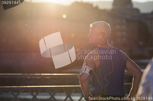 Image of portrait of handsome senior jogging man