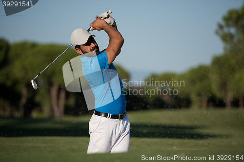 Image of pro golfer hitting a sand bunker shot