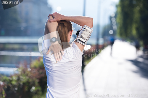 Image of blonde woman  stretching before morning jogging