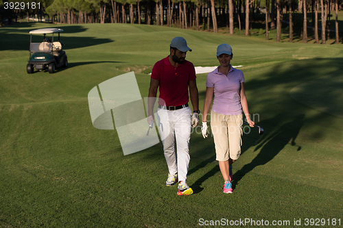 Image of couple walking on golf course