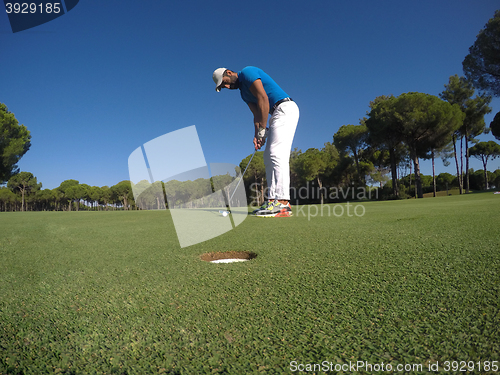 Image of golf player hitting shot at sunny day