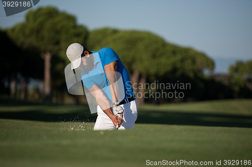 Image of pro golfer hitting a sand bunker shot