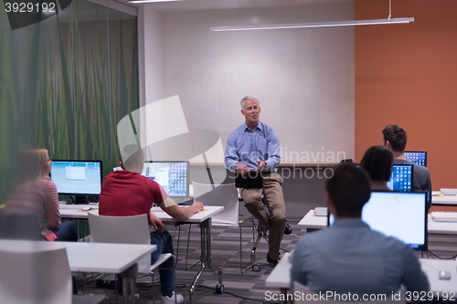 Image of teacher and students in computer lab classroom