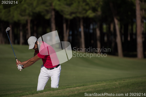 Image of golfer hitting a sand bunker shot