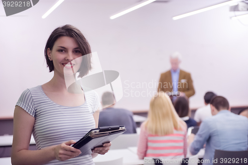 Image of portrait of happy female student in classroom