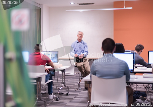 Image of teacher and students in computer lab classroom