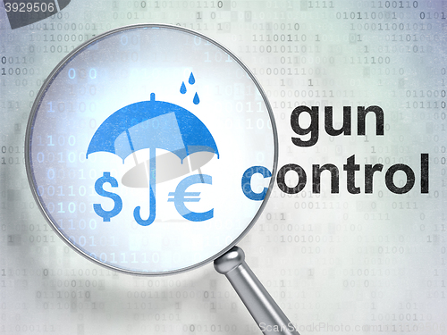 Image of Protection concept: Money And Umbrella and Gun Control with optical glass