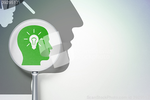 Image of Marketing concept:  Head With Light Bulb with optical glass on digital background