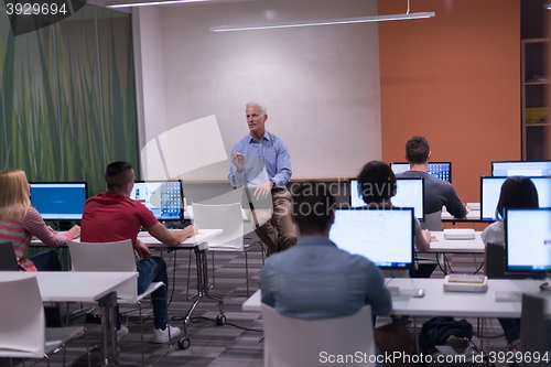 Image of teacher and students in computer lab classroom