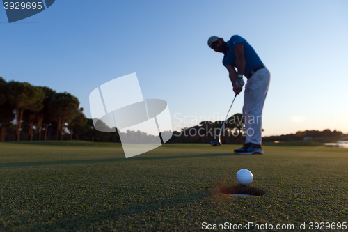 Image of golfer  hitting shot at golf course