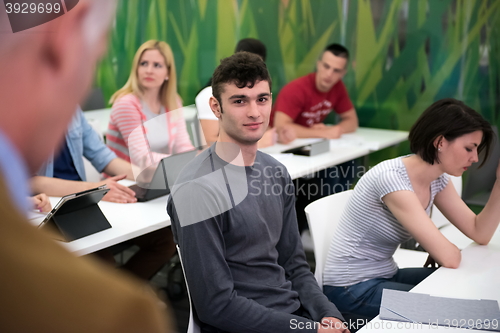 Image of teacher with a group of students in classroom