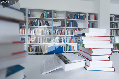 Image of female student study in library, using tablet and searching for 