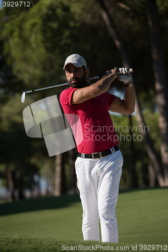 Image of golfer hitting a sand bunker shot