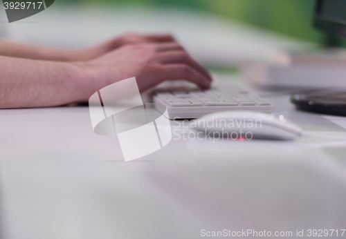 Image of business woman working on computer at office