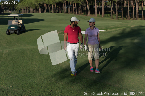 Image of couple walking on golf course