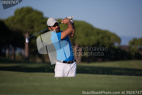 Image of pro golfer hitting a sand bunker shot