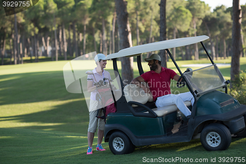 Image of couple in buggy on golf course